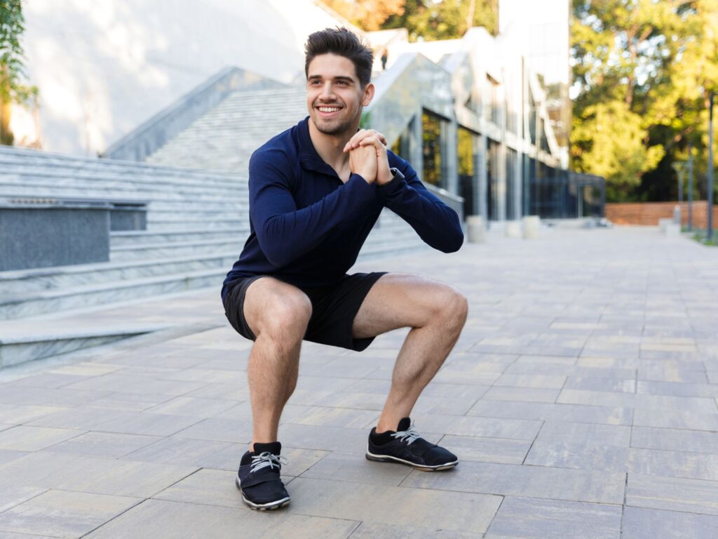 a man doing a squat outside